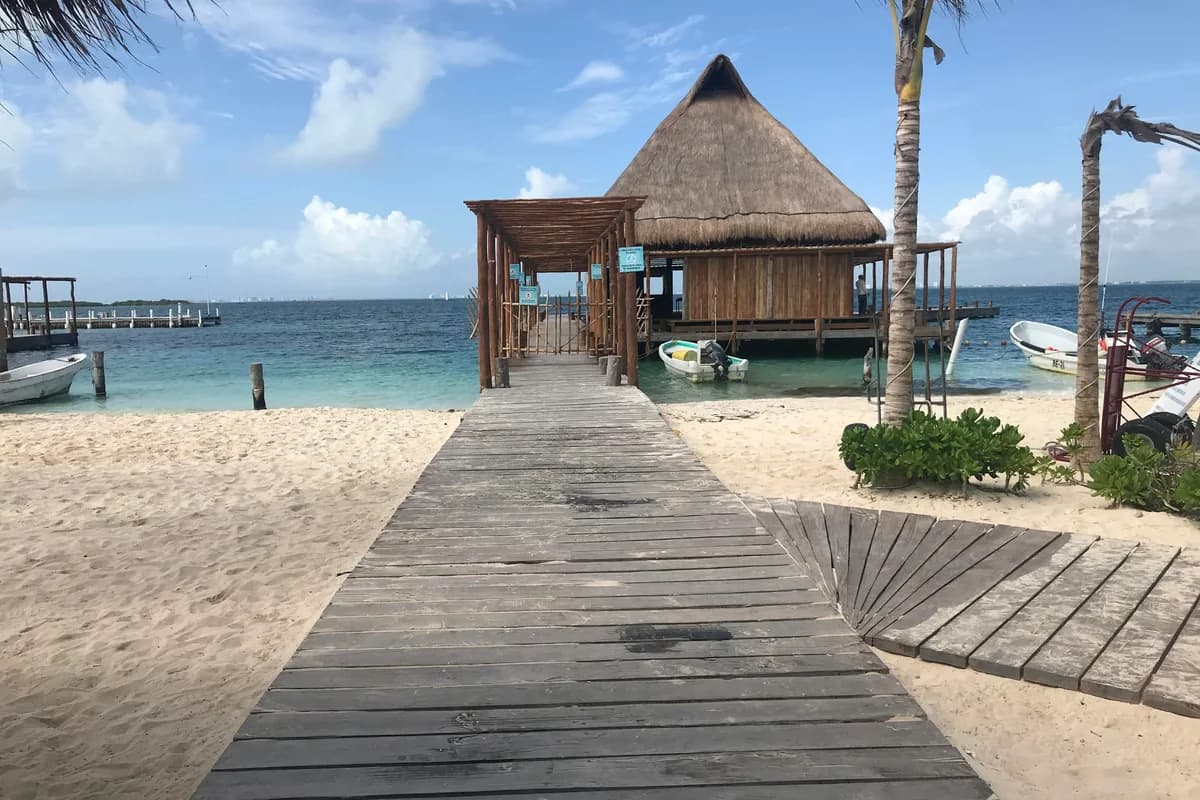 A wooden beach house on the white sand near Cancun