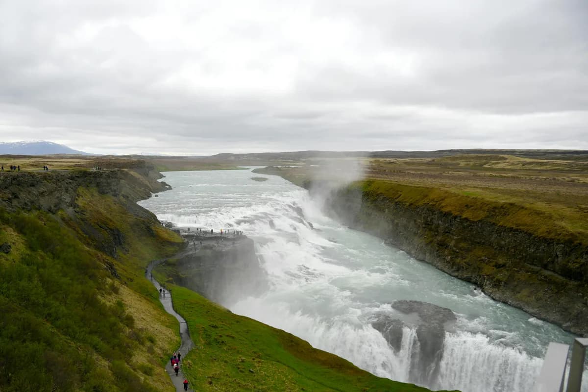 Experience the powerful beauty of Gullfoss Waterfall cascading through Iceland's rugged landscape.