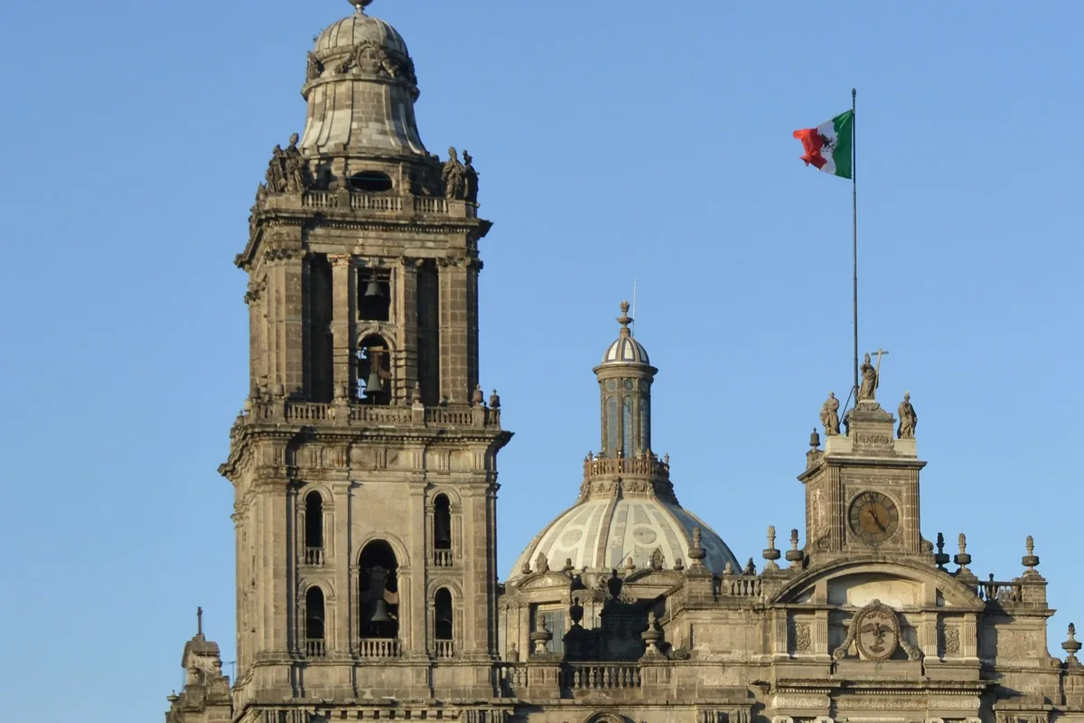 The Metropolitan Cathedral and Mexican flag in the Zocalo, Mexico City