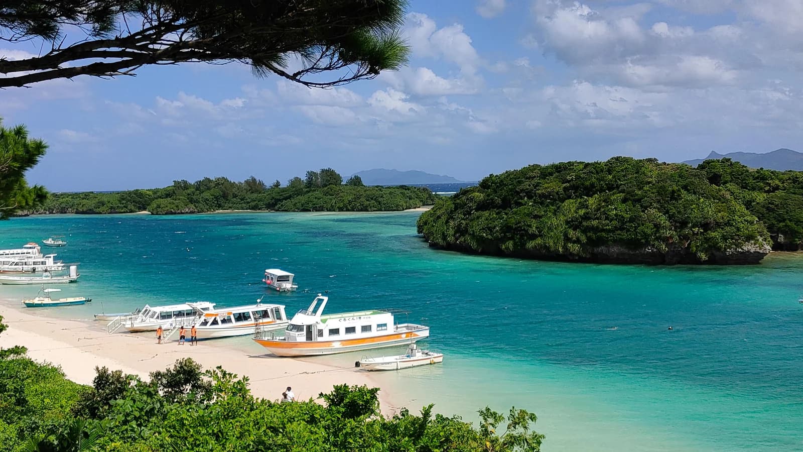 Turquoise waters and beaches of Ishigaki, Okinawa with boats moored offshore