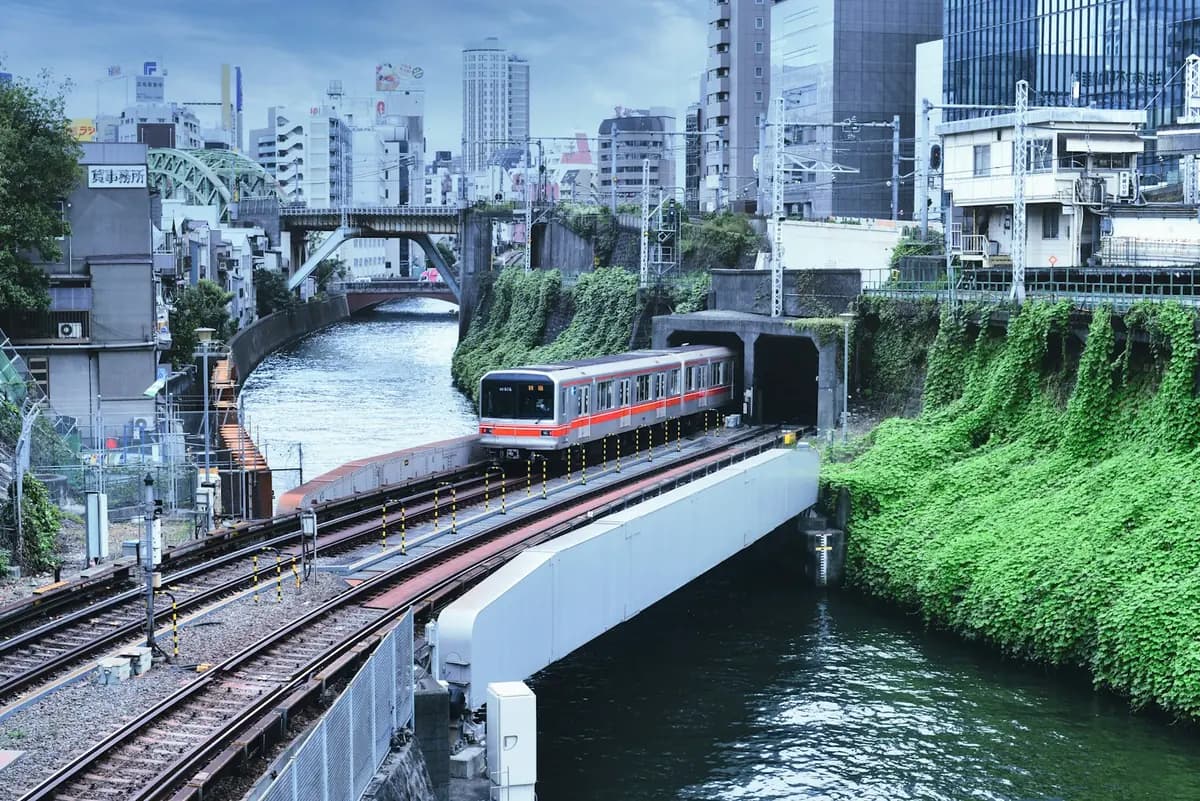 A Marunouchi Line train crossing the Kanda River at Ochanomizu, between Tokyo buildings